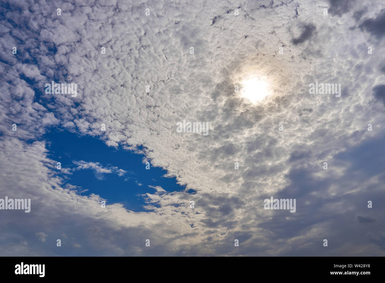 A beautiful view of the summer sun behind the clouds Stock Photo
