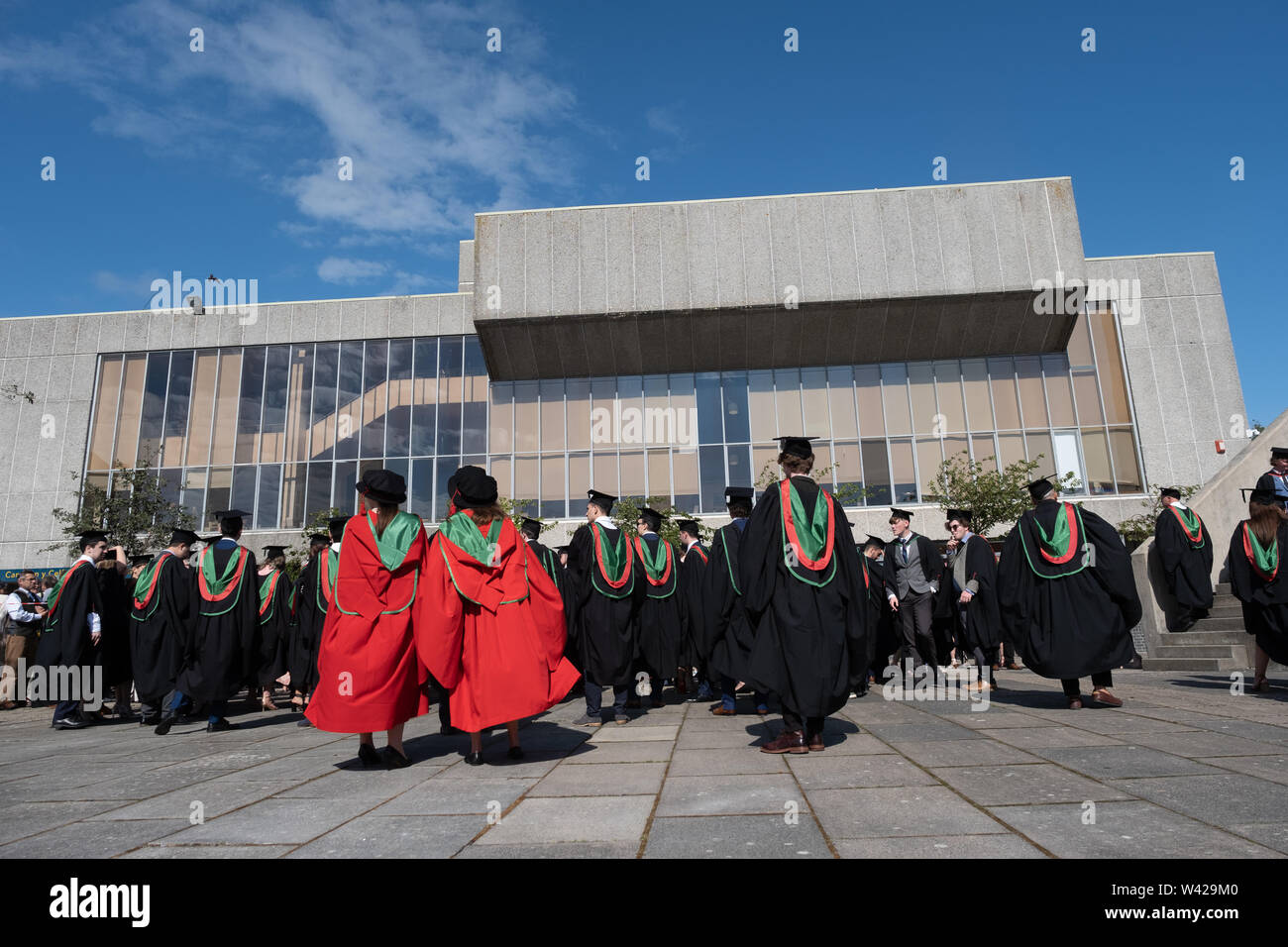 Higher education in the UK - successful students at the graduation ceremony at Aberystwyth university, after receiving their degrees,  wearing their traditional caps and gowns. July 2019 Stock Photo