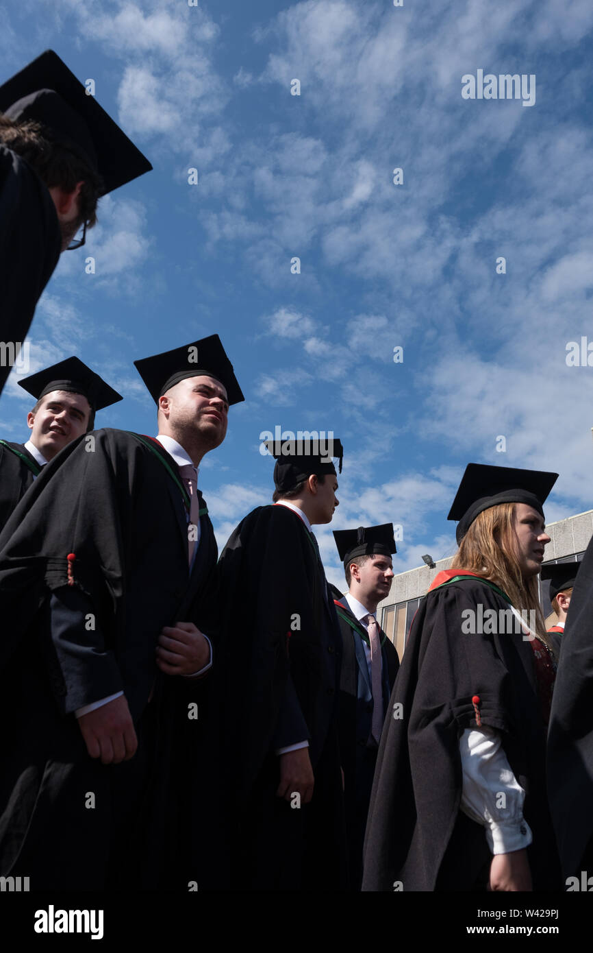 Higher education in the UK - successful students at the graduation ceremony at Aberystwyth university, after receiving their degrees,  wearing their traditional caps and gowns. July 2019 Stock Photo