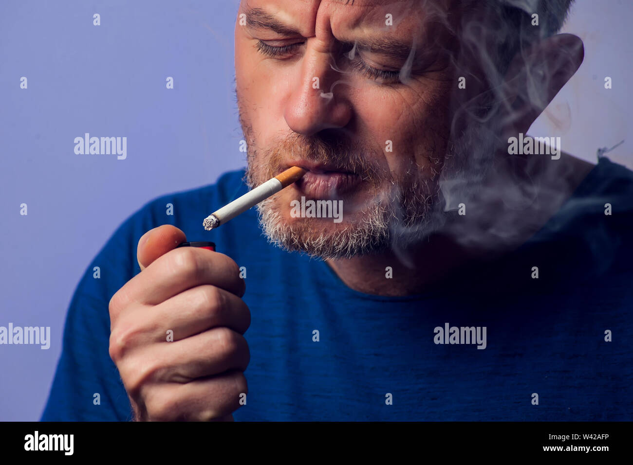 Close up of Man smoking cigarette. People, healt care concept Stock Photo