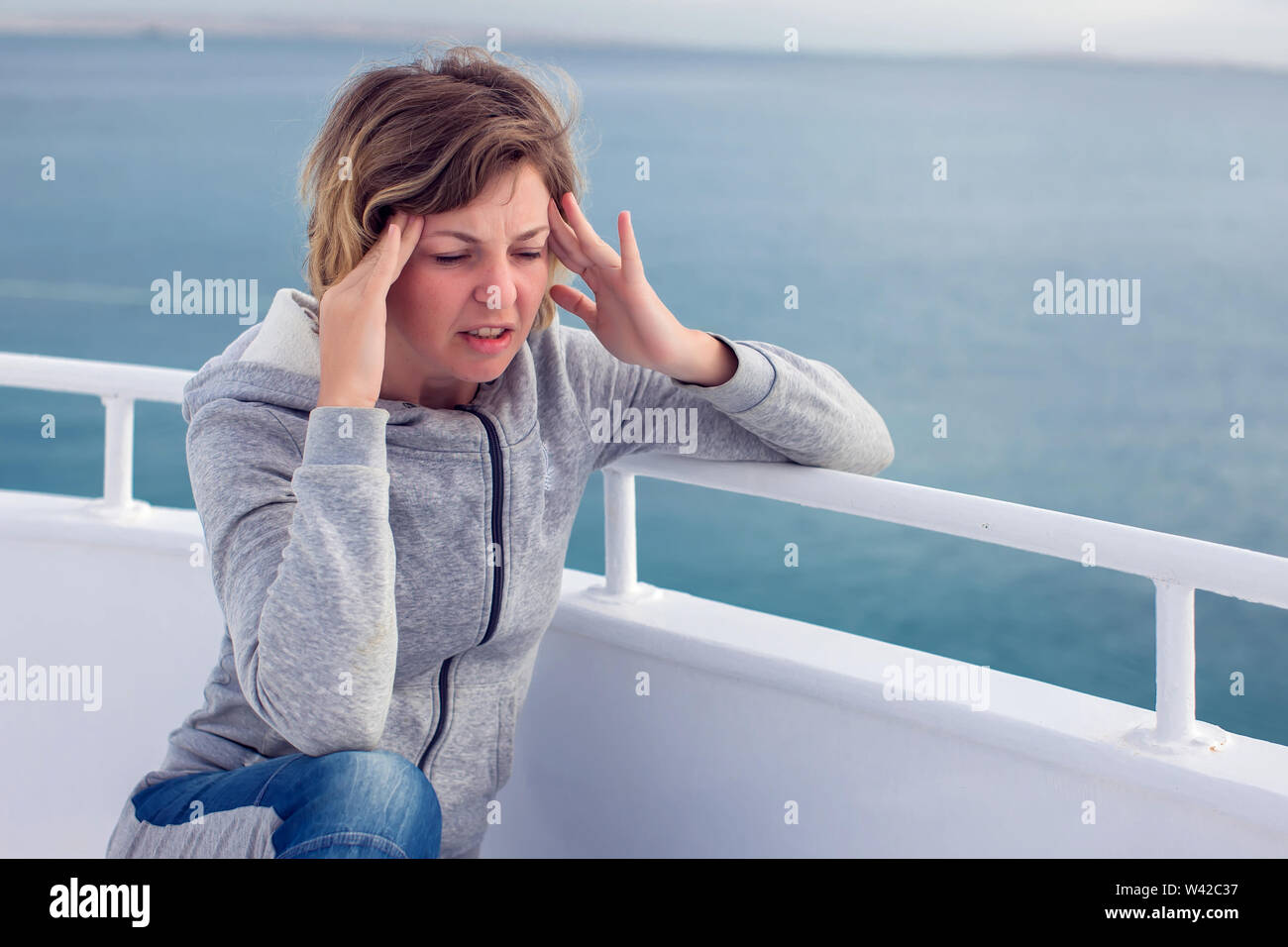 Cruise sea motion sickness tourist woman seasick on boat vacation with