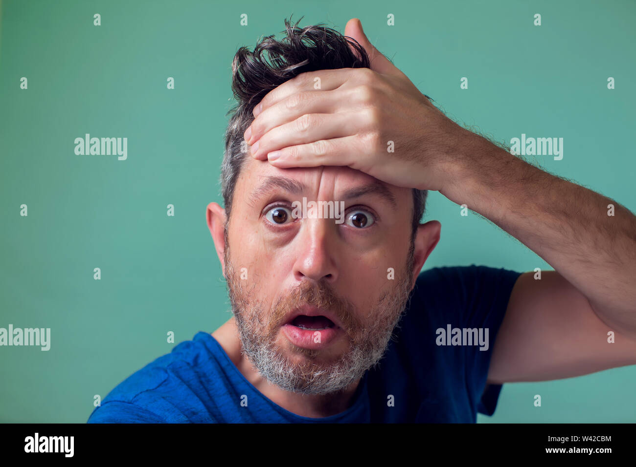 People and emotions - man with beard surprised about something Stock Photo