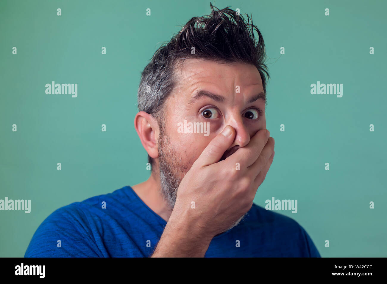 People and emotions - man with beard surprised about something Stock Photo