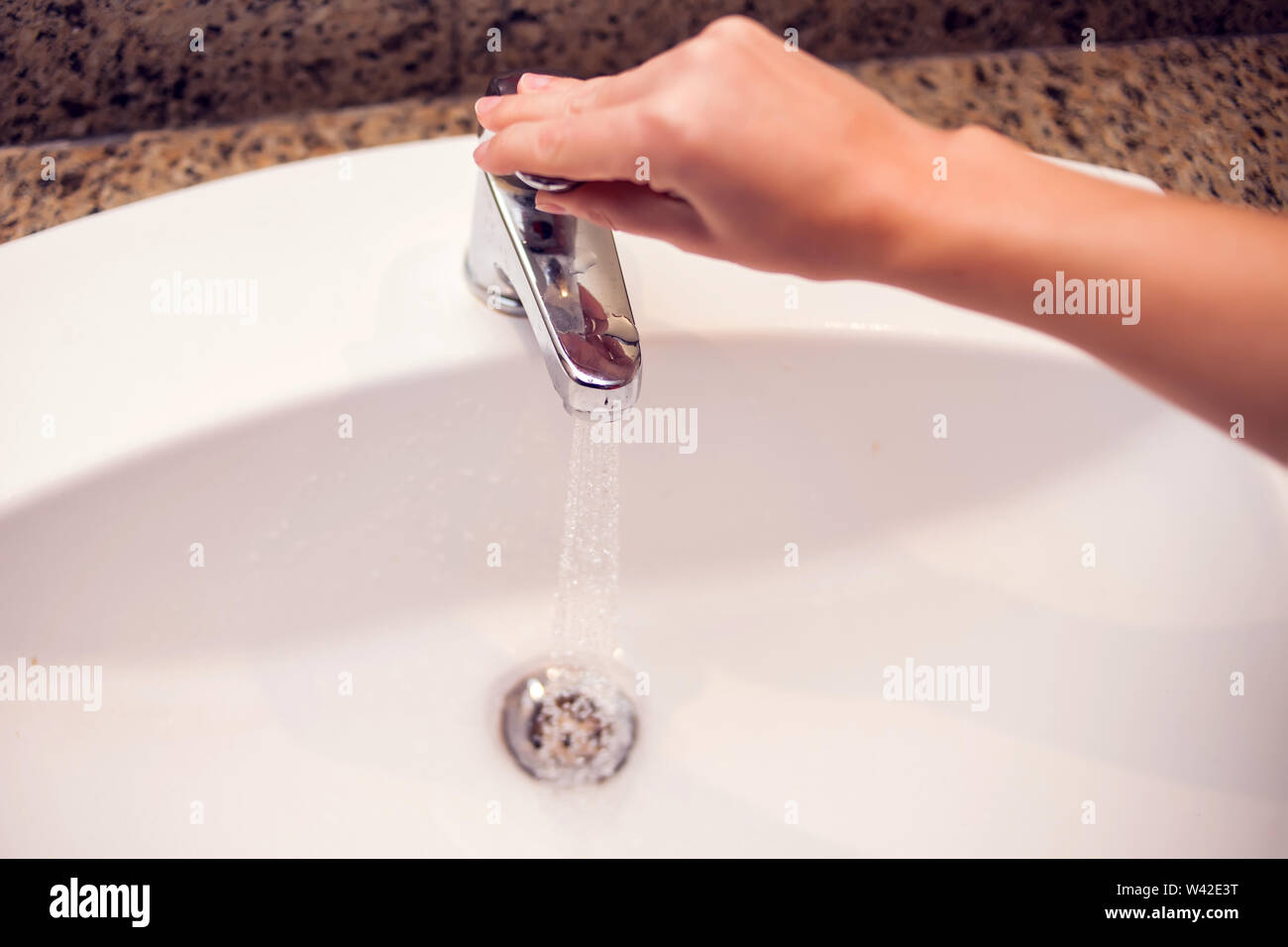 Open chrome faucet water washbasin in the bathroom Stock Photo - Alamy