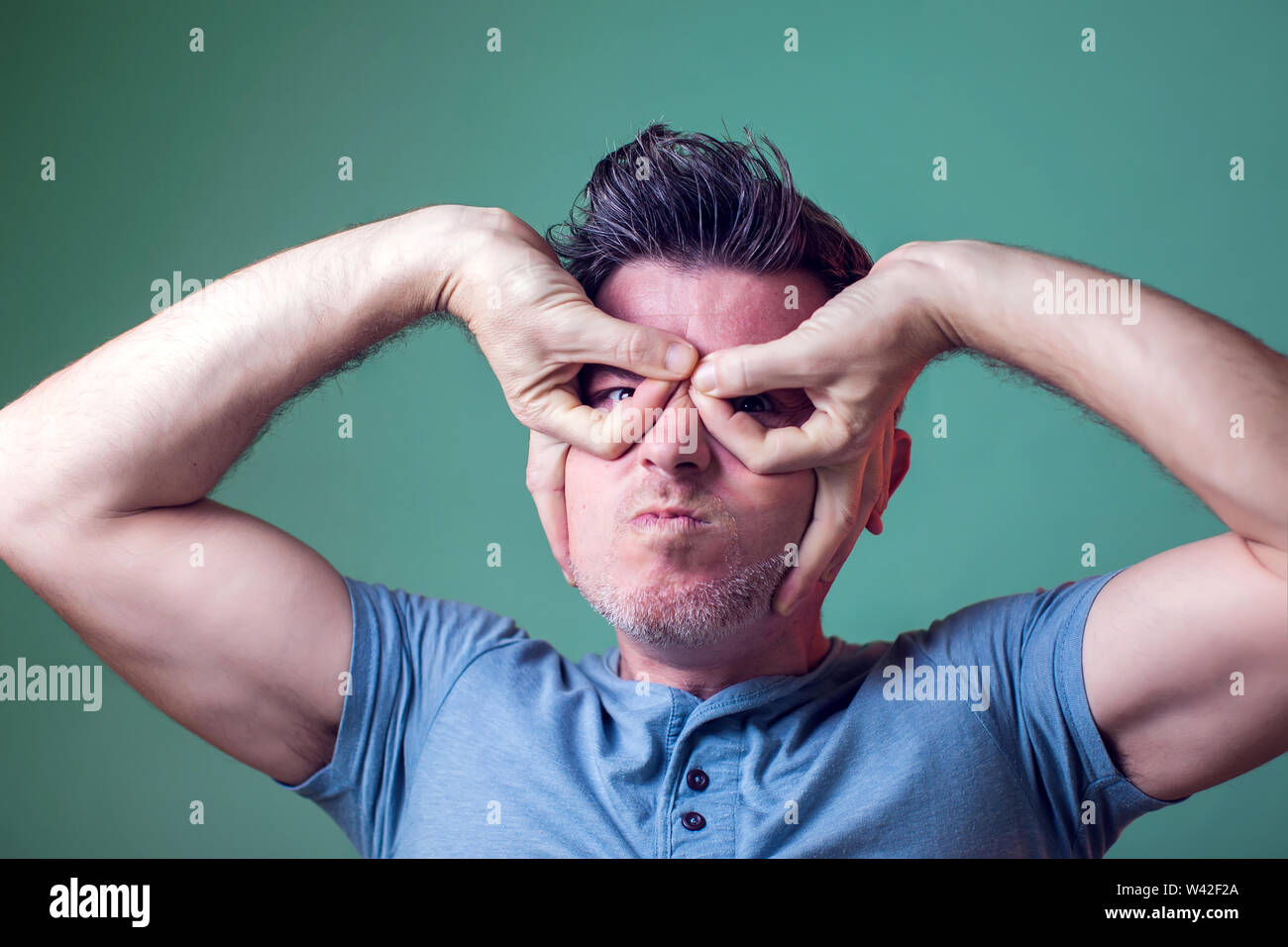 Funny man making finger mask hero. Heroic mood of super man. People,  emotions and lifestyle Stock Photo - Alamy