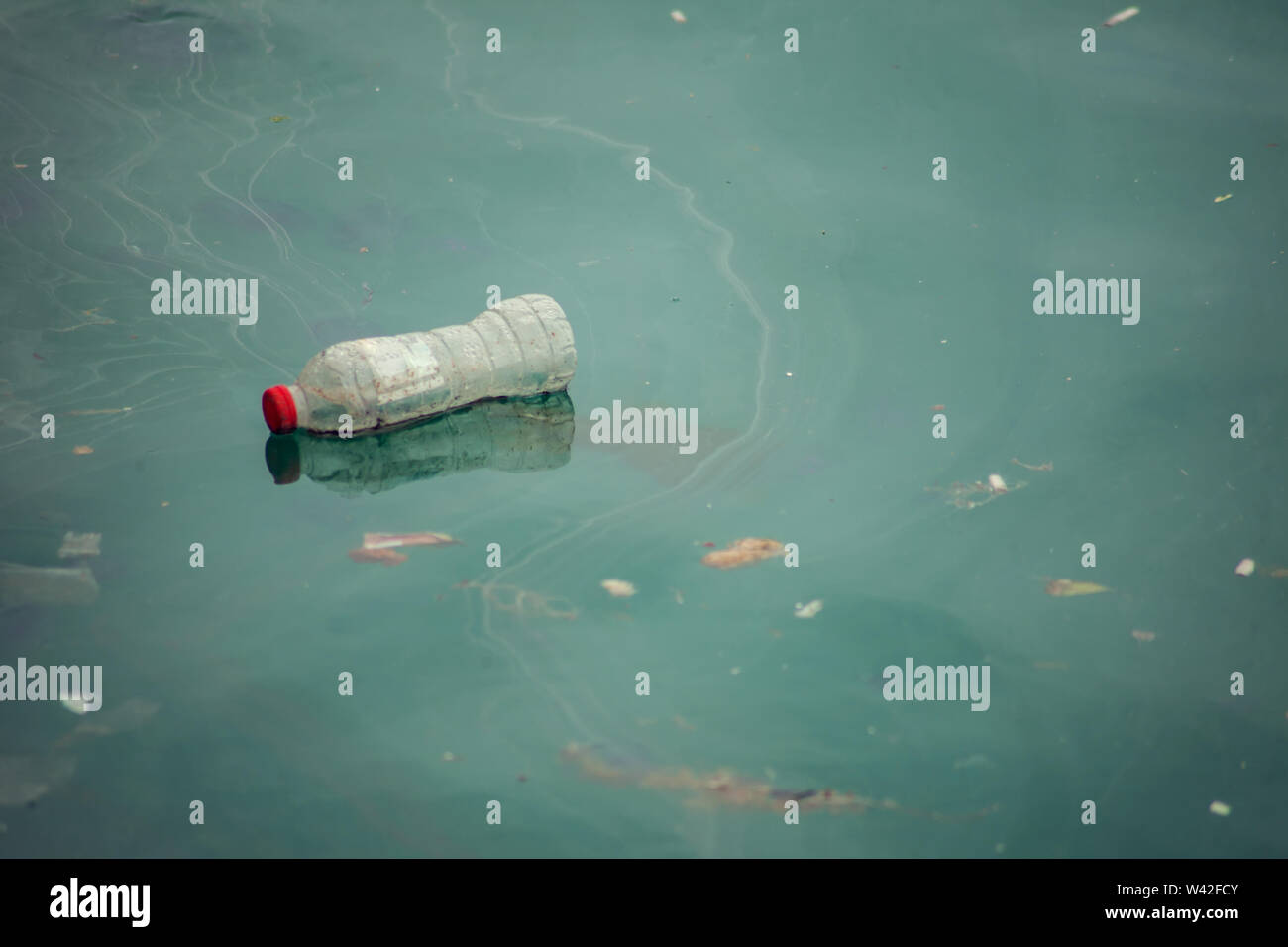 Plastic trash in sea or ocean. Plastic bottles, bags, straws and cups