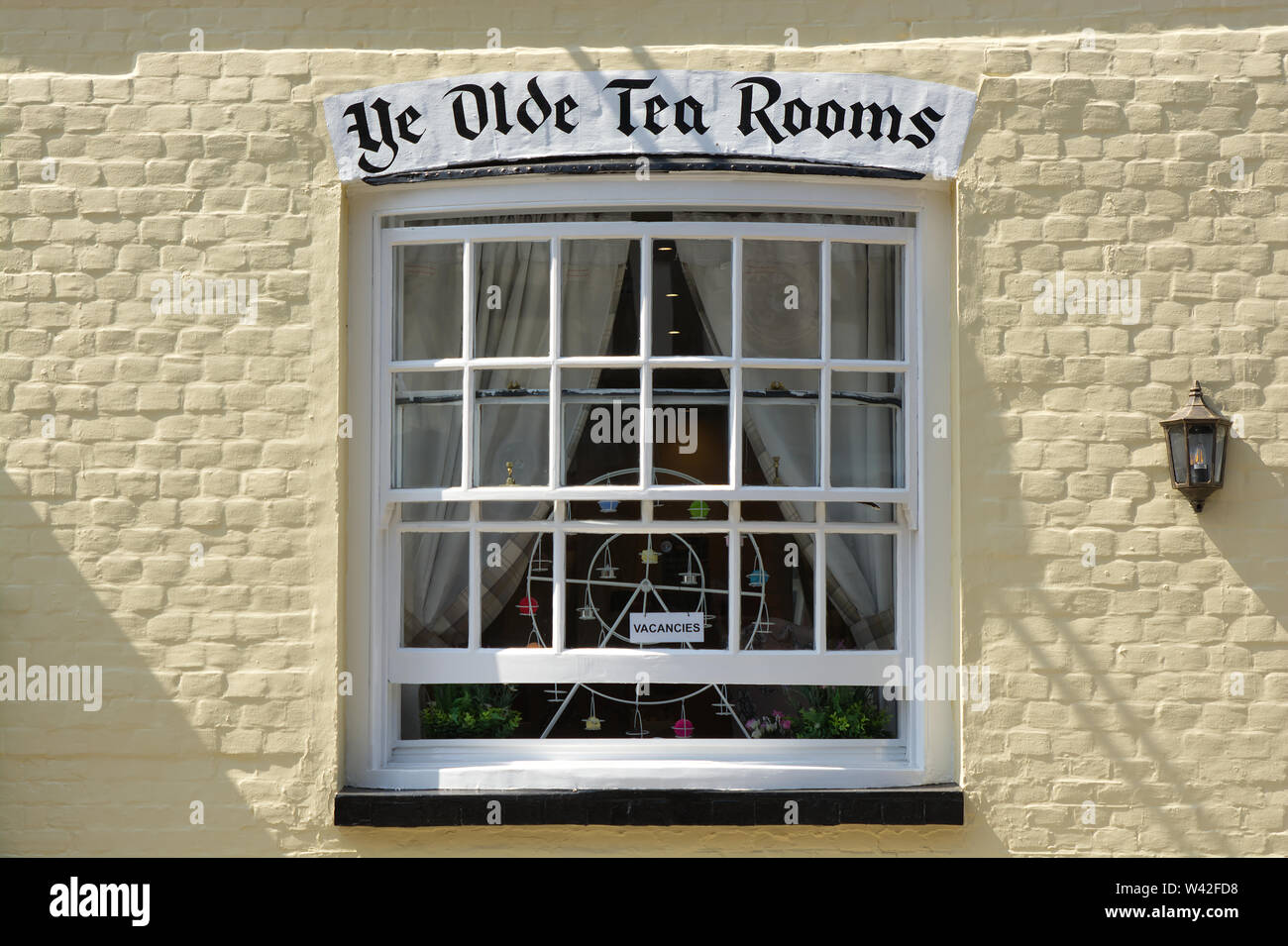 Ye Olde Tea Rooms sign over window in brick wall, England Stock Photo