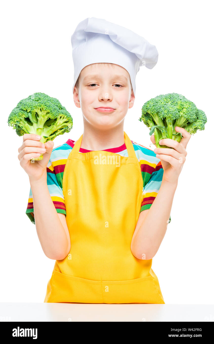 little cook in hat and apron with broccoli on white background isolated Stock Photo
