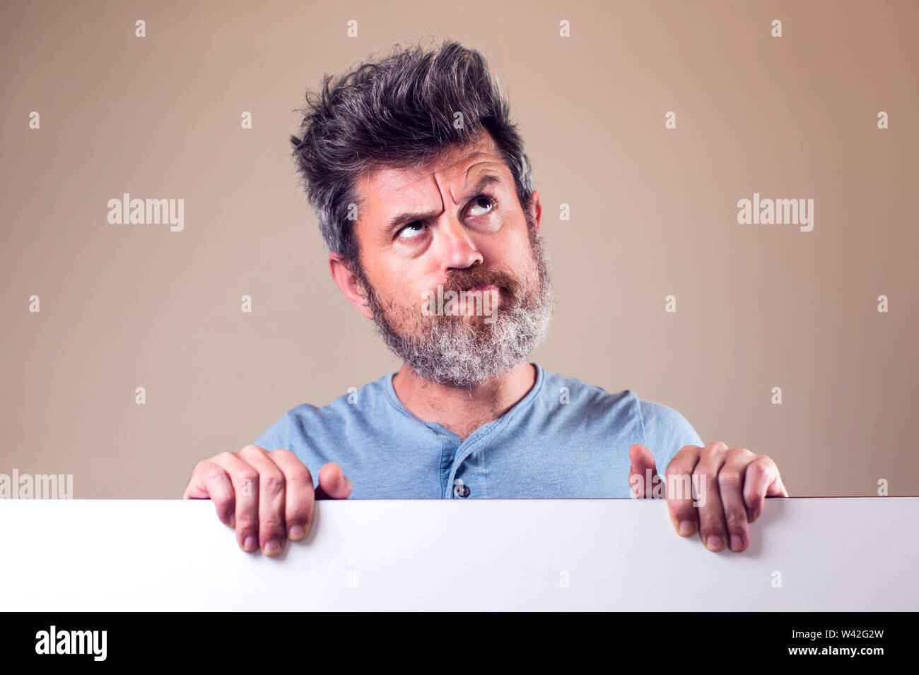 Surprised young bearded man. Emotions and people concept Stock Photo