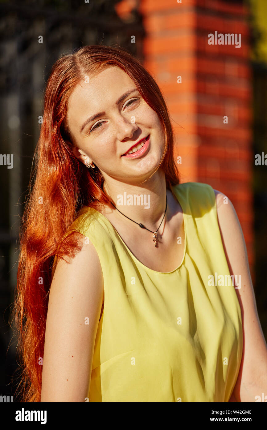 Pretty Red Hair Girl In Sun Light Looking At Camera Smiling Stock