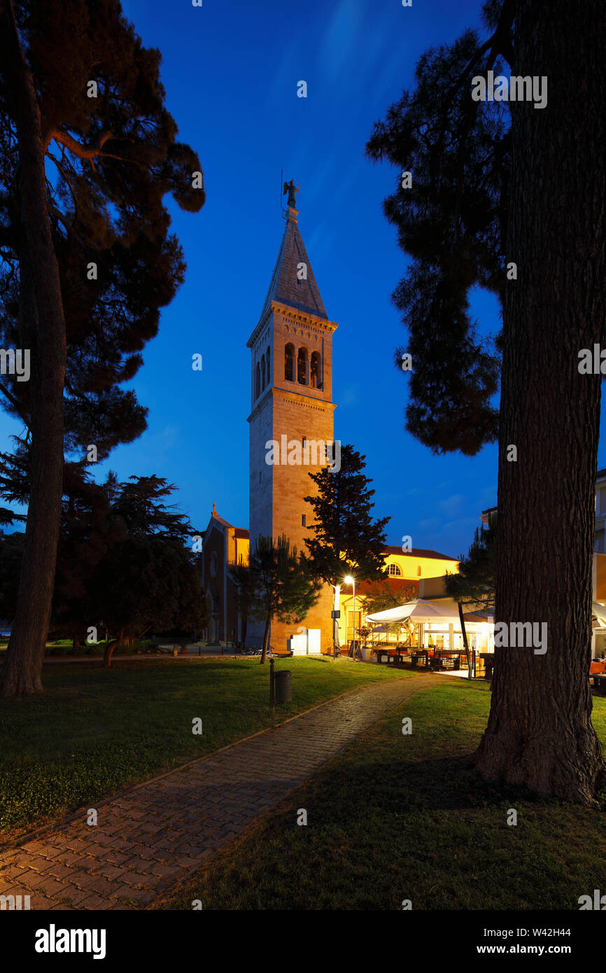 View of bell tower of the church St.Pelage and  St.Benedetto during twilight from small park,Novigrad,Istria,Croatia Stock Photo