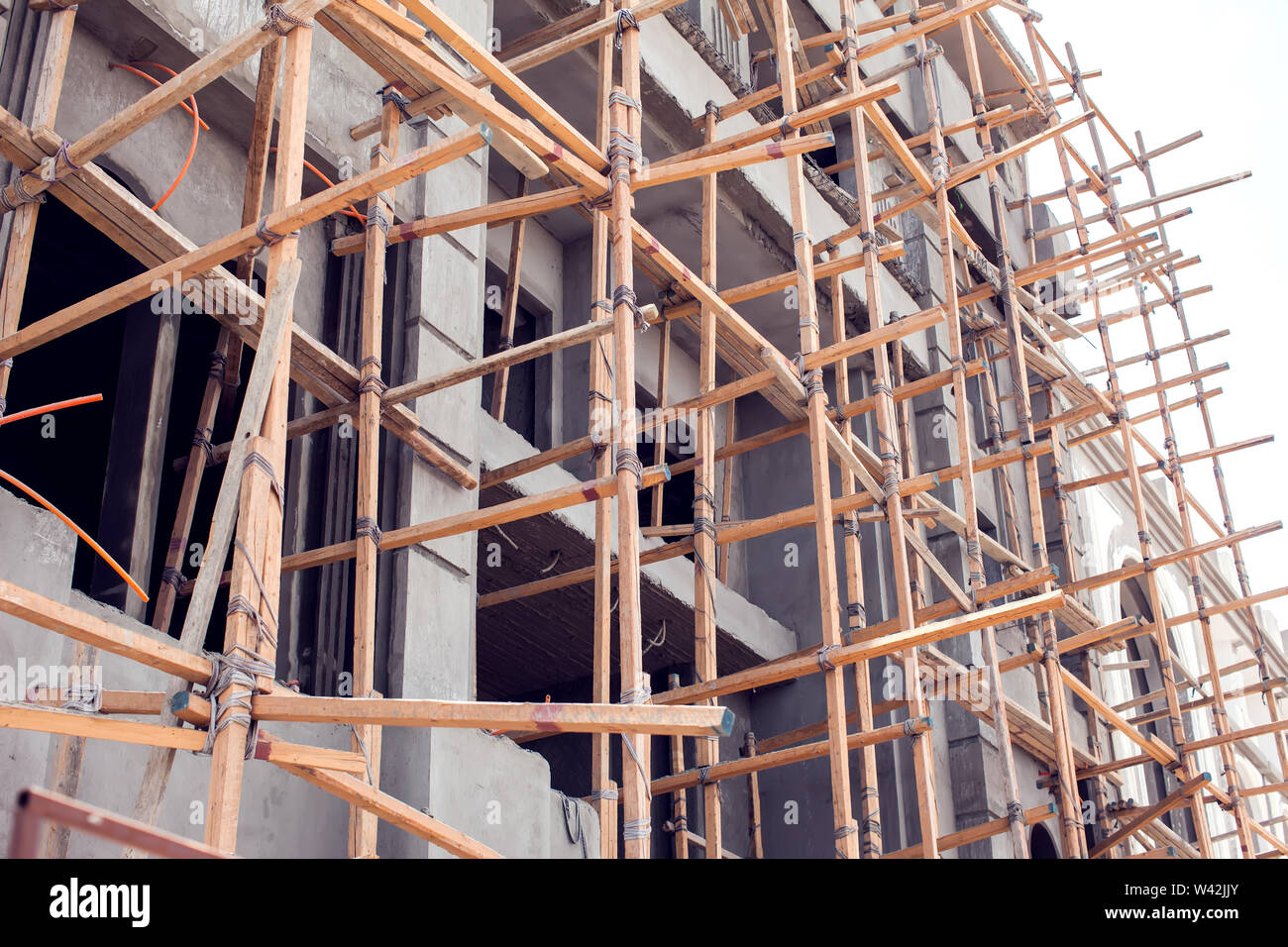 House with wooden scaffolding construction. Architecture and building  concept Stock Photo - Alamy