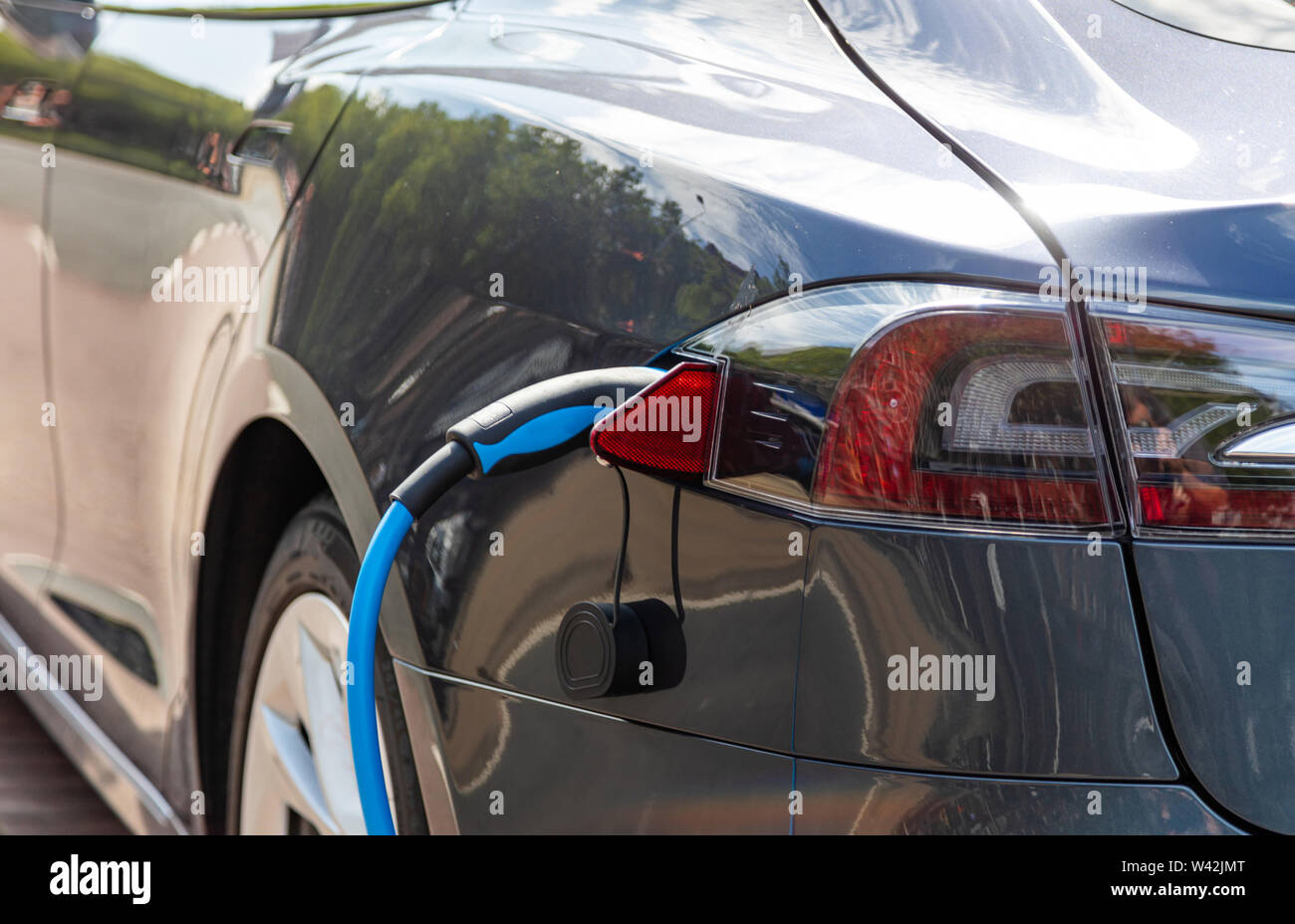 Charging the electric vehicle battery . EV fuel Plug in hybrid car close up view Stock Photo