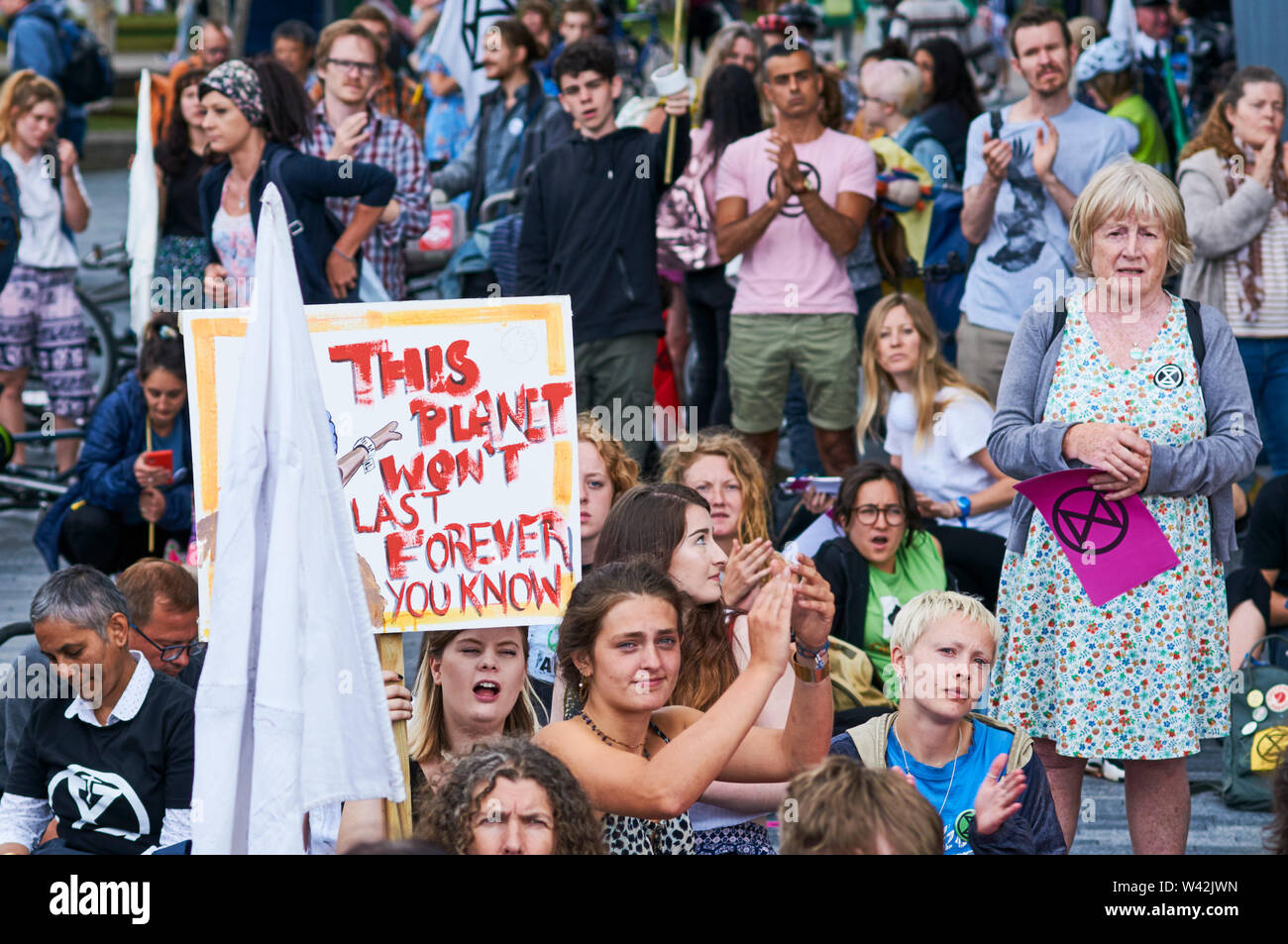 Extinction Rebellion climate change protesters listening to speeches outside City Hall on London's South Bank, on the 18th July 2019 Stock Photo