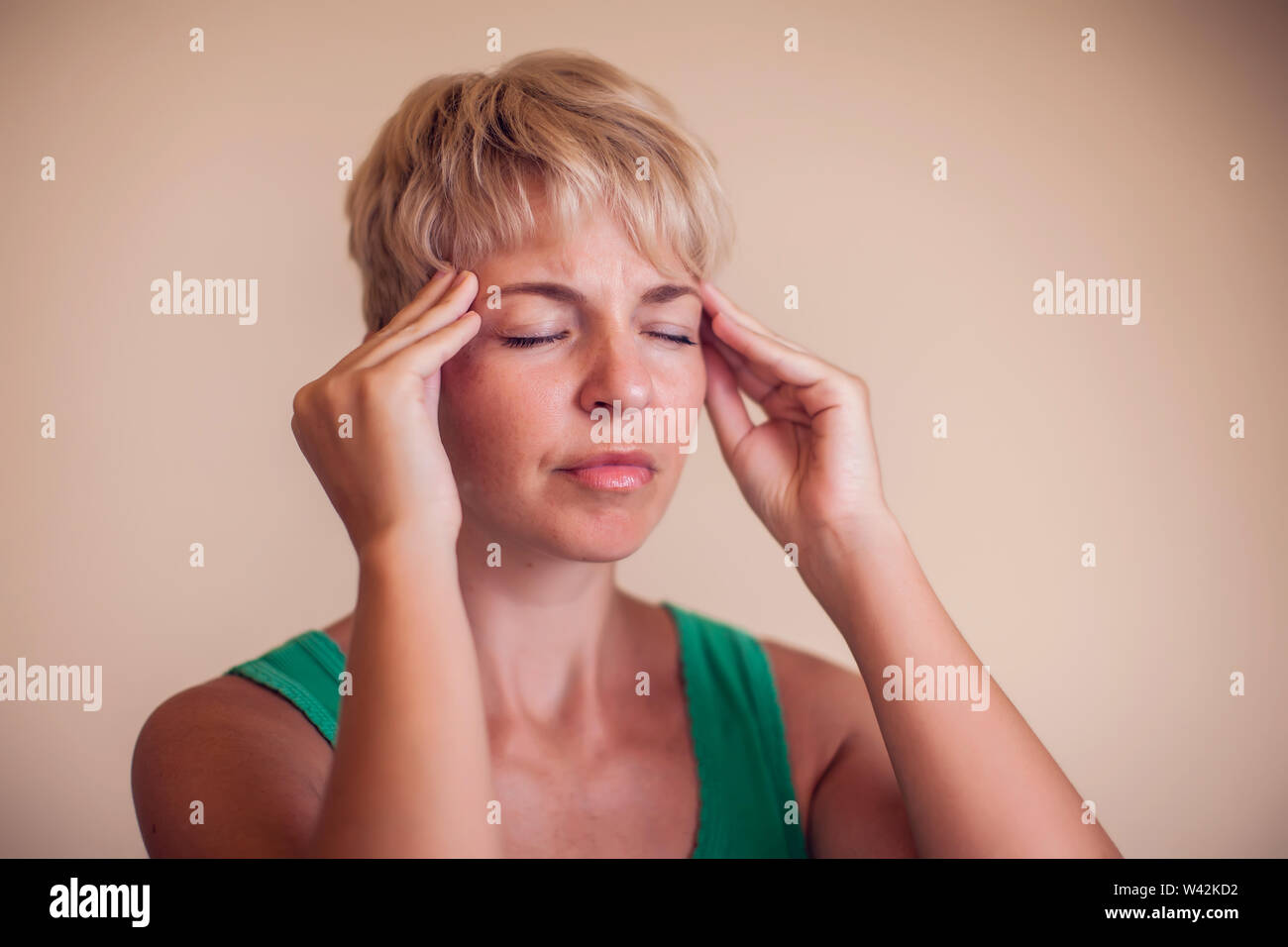Woman with short hair feels strong headache isolated. People