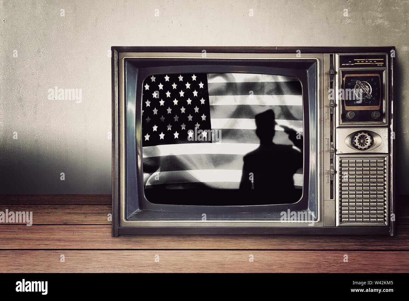 silhouette of soldier on american flag in vintage television on wooden table. Independence day , National american holiday. Stock Photo