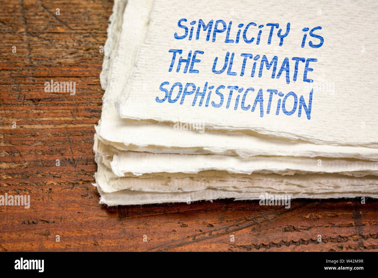 Simplicity is the ultimate sophistication - inspirational handwriting on a handmade rag paper Stock Photo