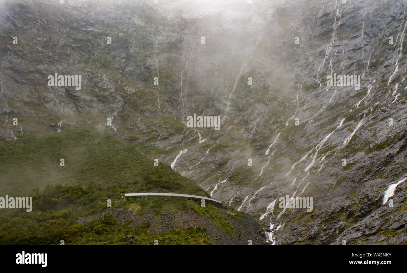 Misty waterfalls of MIlford Sound, New Zealand Stock Photo