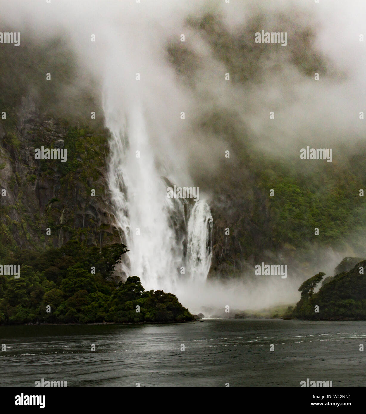 Misty waterfalls of MIlford Sound, New Zealand Stock Photo