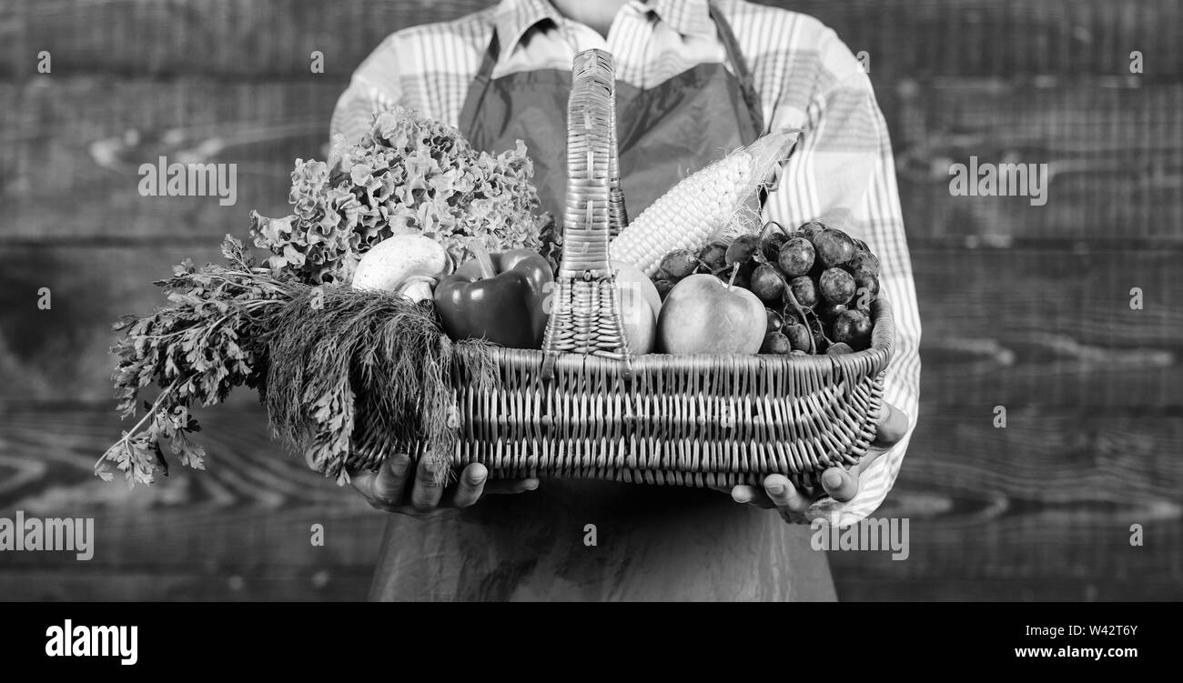 Man farmer presenting eco vegetables wooden background. Fresh organic ...