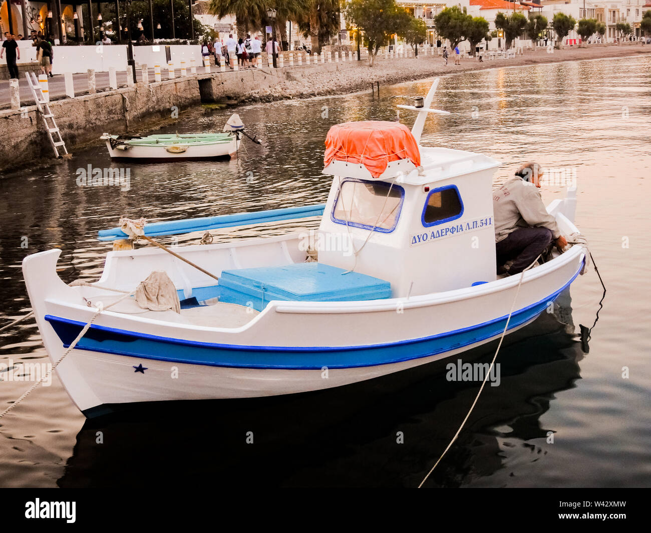 Little Blue and White Fishing Boat with man Fishing, Patmos, Greek ...