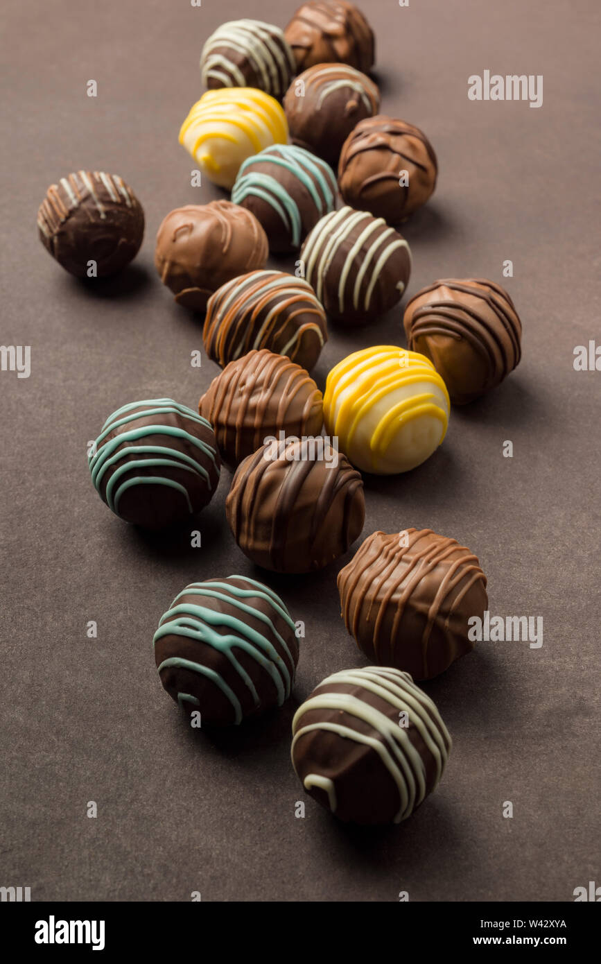 chocolates praline variety on brown background Stock Photo