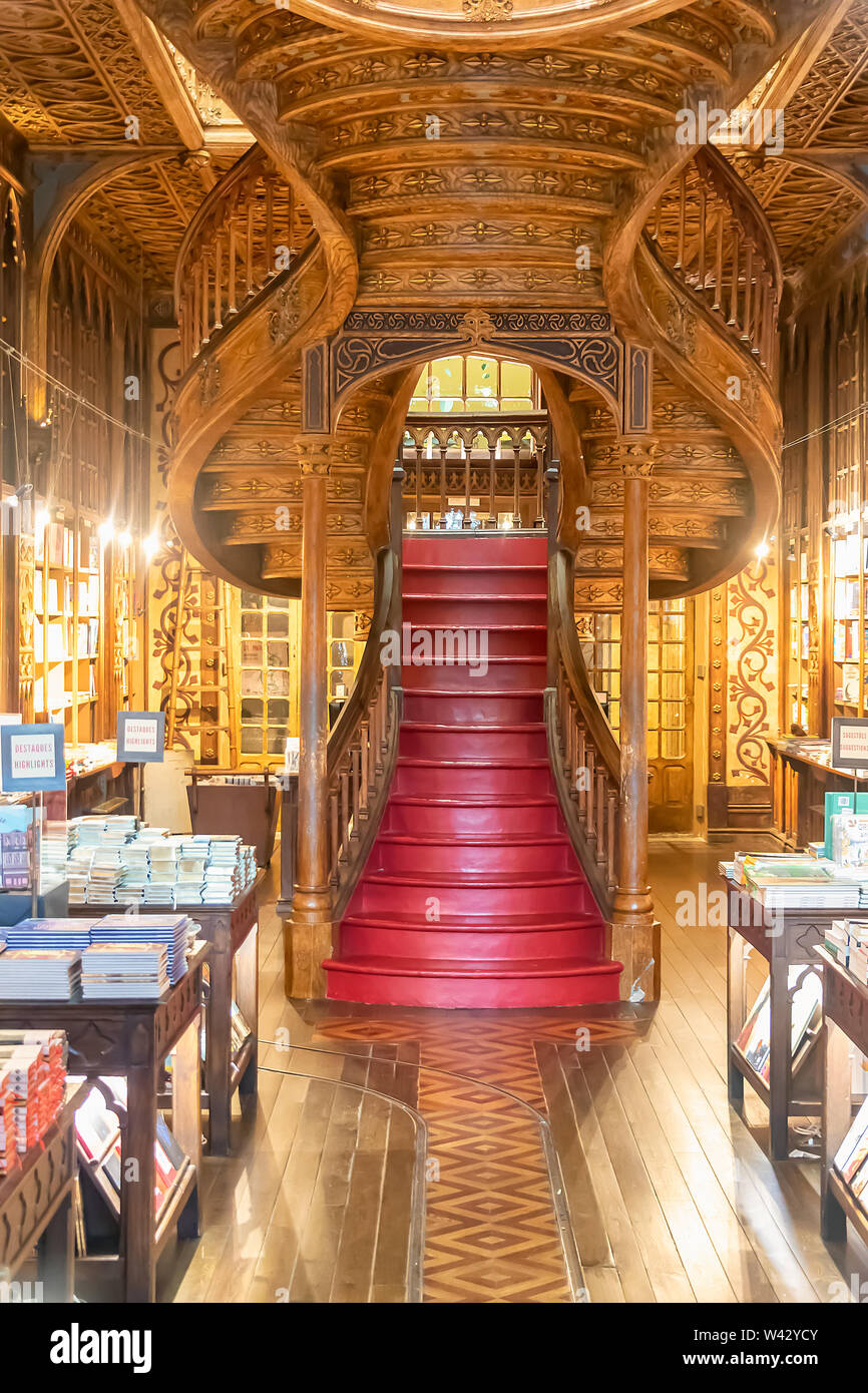 Large wooden staircase with red steps inside Library Lello and Irmao in historic center of Porto Stock Photo