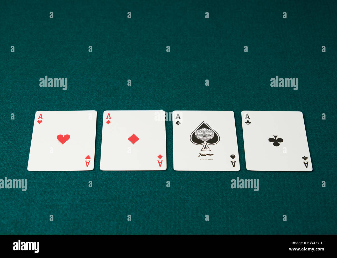 poker game of aces displayed the cards on green carpet in the background  Stock Photo - Alamy