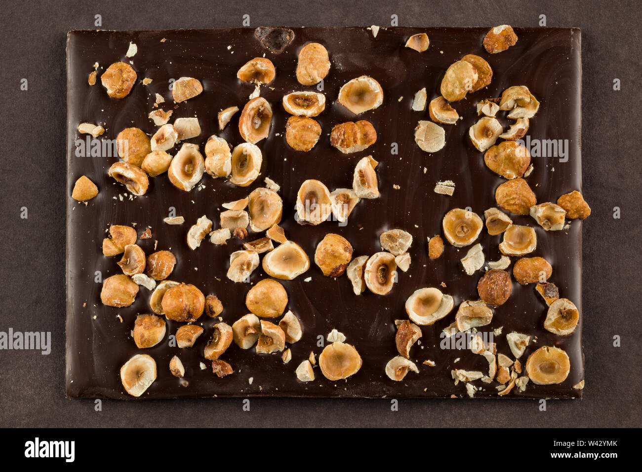 hazelnut dark chocolate bar on brown background Stock Photo Alamy