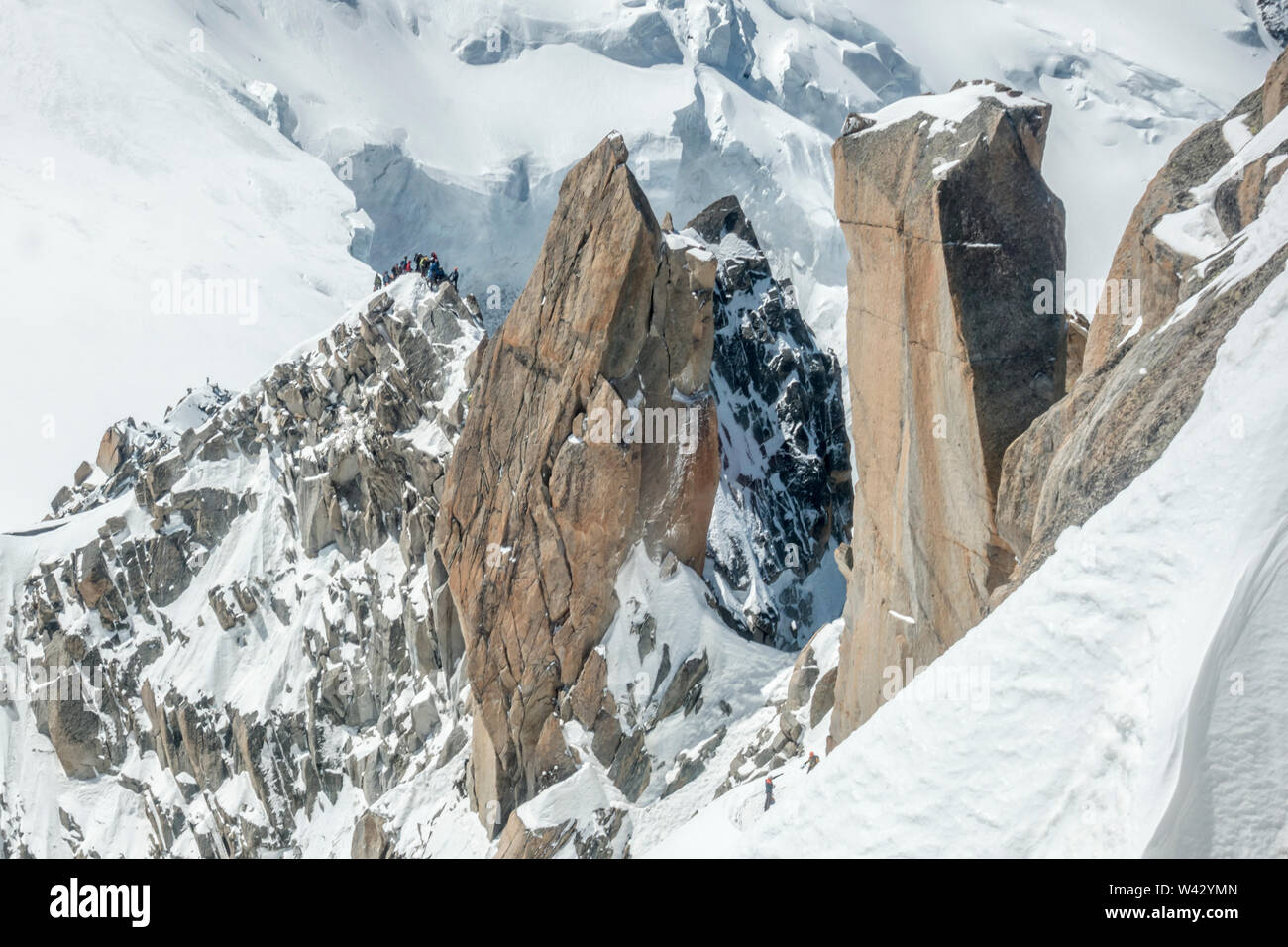 Mont Blanc's famous Cosmiques Ridge on a sunny day, climber traffic Stock Photo