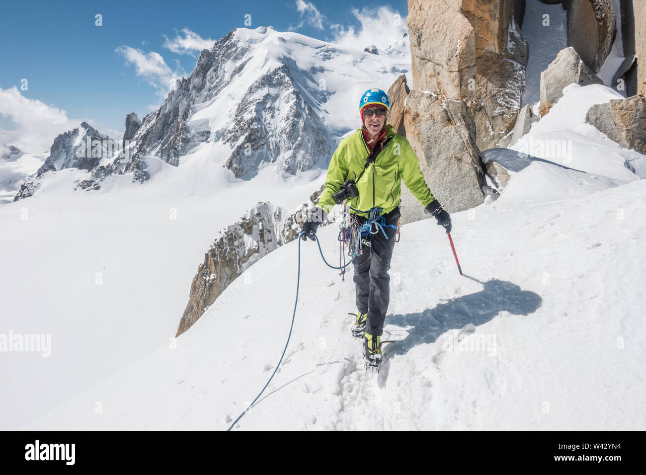 Smiling alpinist on easy ground on the famous Cosmiques Ridge Stock Photo