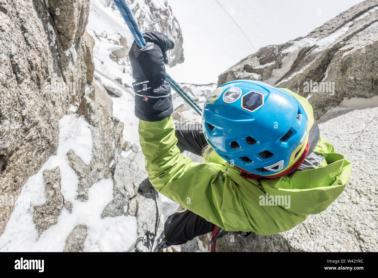 Alpinist rappelling steep terrain high above a Mont Blanc glacier Stock Photo
