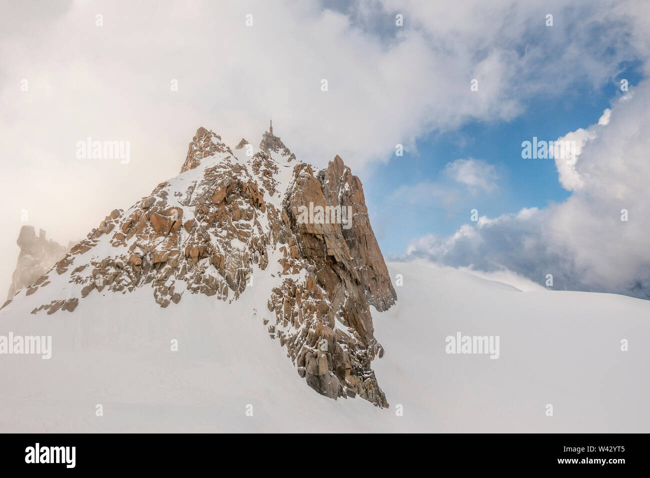 The famous Aiguille du Midi amid clouds in late evening light Stock ...