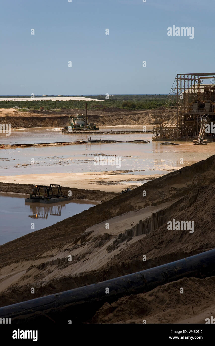 Managing & transporting of titanium mineral sands at mine site. Mining by dredging in freshwater ponds. Dredges pump sand into wet concentrator plant. Stock Photo