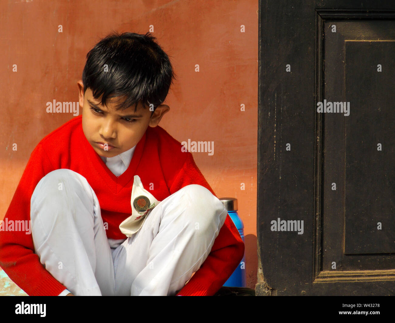 A school boy participating in a painting competition and thinking about the subject of his creation in a local school of Assam, India Stock Photo