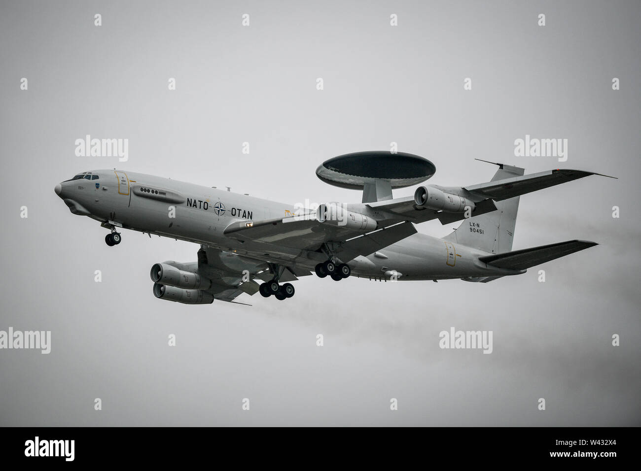 A lone Boeing E-3A Sentry takes to the skies as part of the NATO 70th anniversary flypast as the other aircraft involved in the flypast had to cancel at the Royal International Air Tattoo, RAF Fairford, as bad weather including strong winds, low cloud and rain have grounded many of the planned air displays. Stock Photo