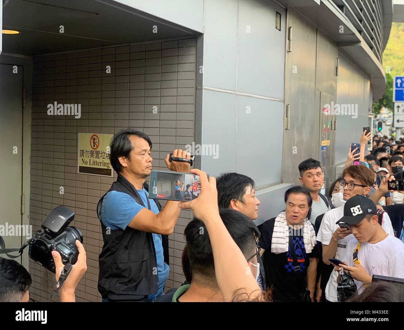 Tuen Mun, Hong Kong-July 6 2019: the police take a video and surround by the  protesters in Tuen Mun .the protesters took to the streets of Hong Kong to oppose a controversial extradition bill. Stock Photo