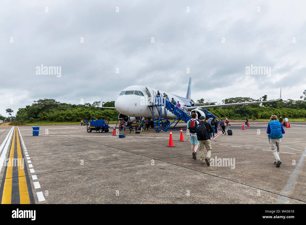 Boarding an Airbus A320 plane on the tarmac at Puerto Maldonado airport, Tambopata, Peru, South America, Stock Photo