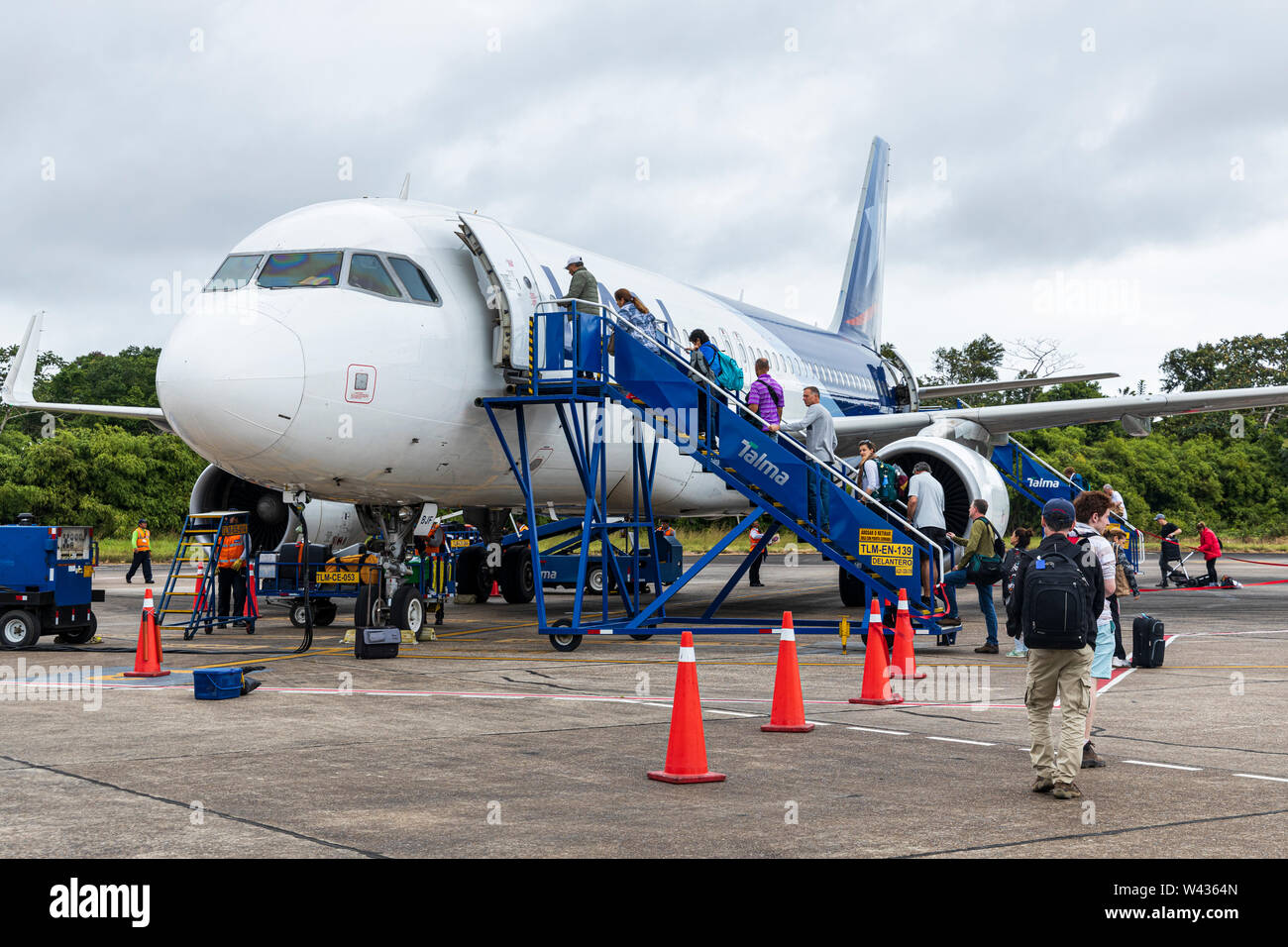 Boarding an Airbus A320 plane on the tarmac at Puerto Maldonado airport, Tambopata, Peru, South America, Stock Photo