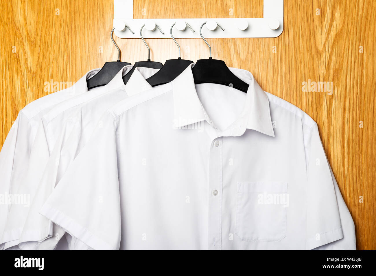 Back to school concept, school uniform such as white shirts hanging on