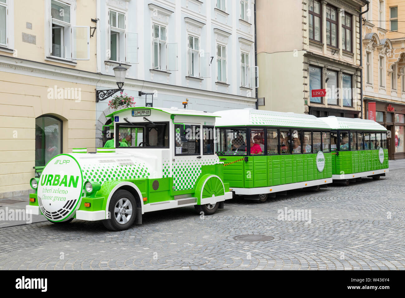 Environmentally-friendly circular tourist train ride with the Urban electric train in central Ljubljana Slovenia EU Europe Stock Photo