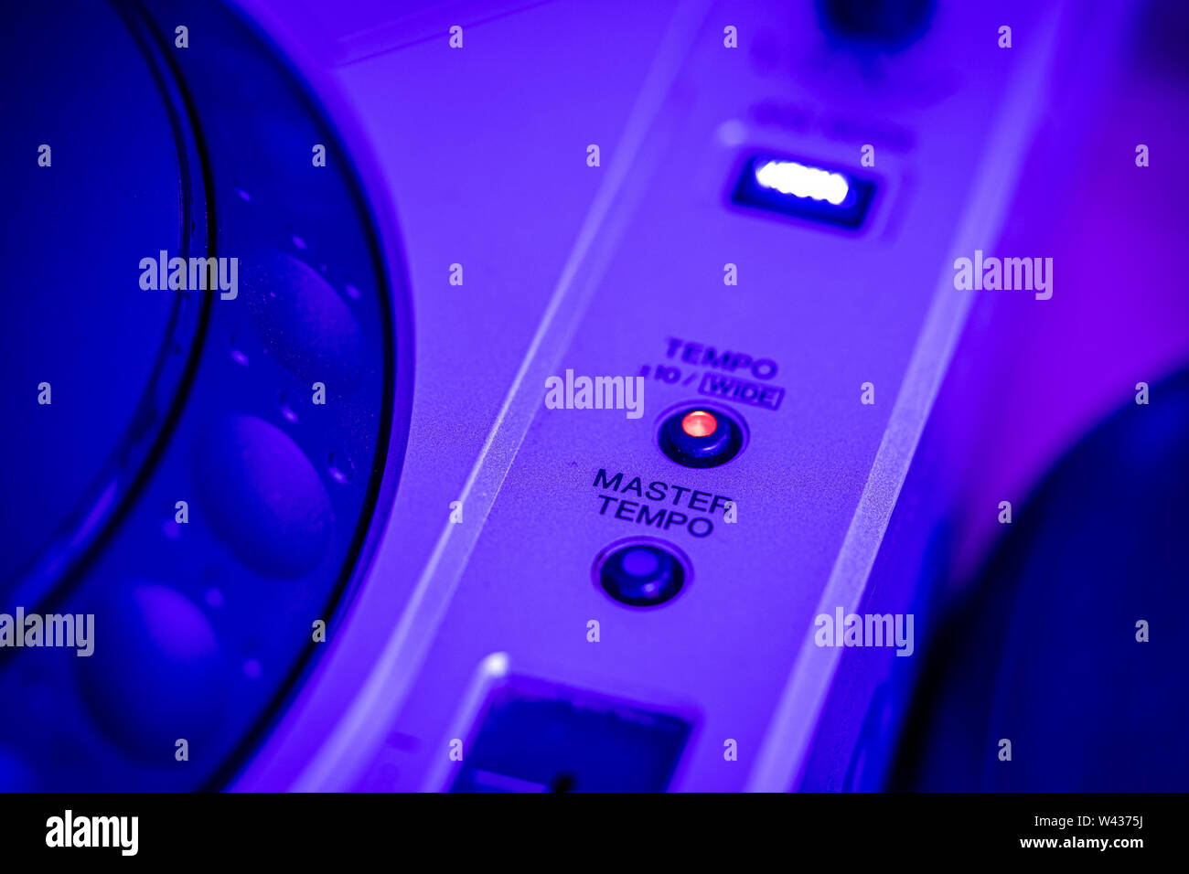 JULY 19, 2019 - MALAGA, SPAIN. Closeup of Master Tempo control on a Pioneer CDJ 800 Mk2 CD Player. Blue stage lighting. Stock Photo