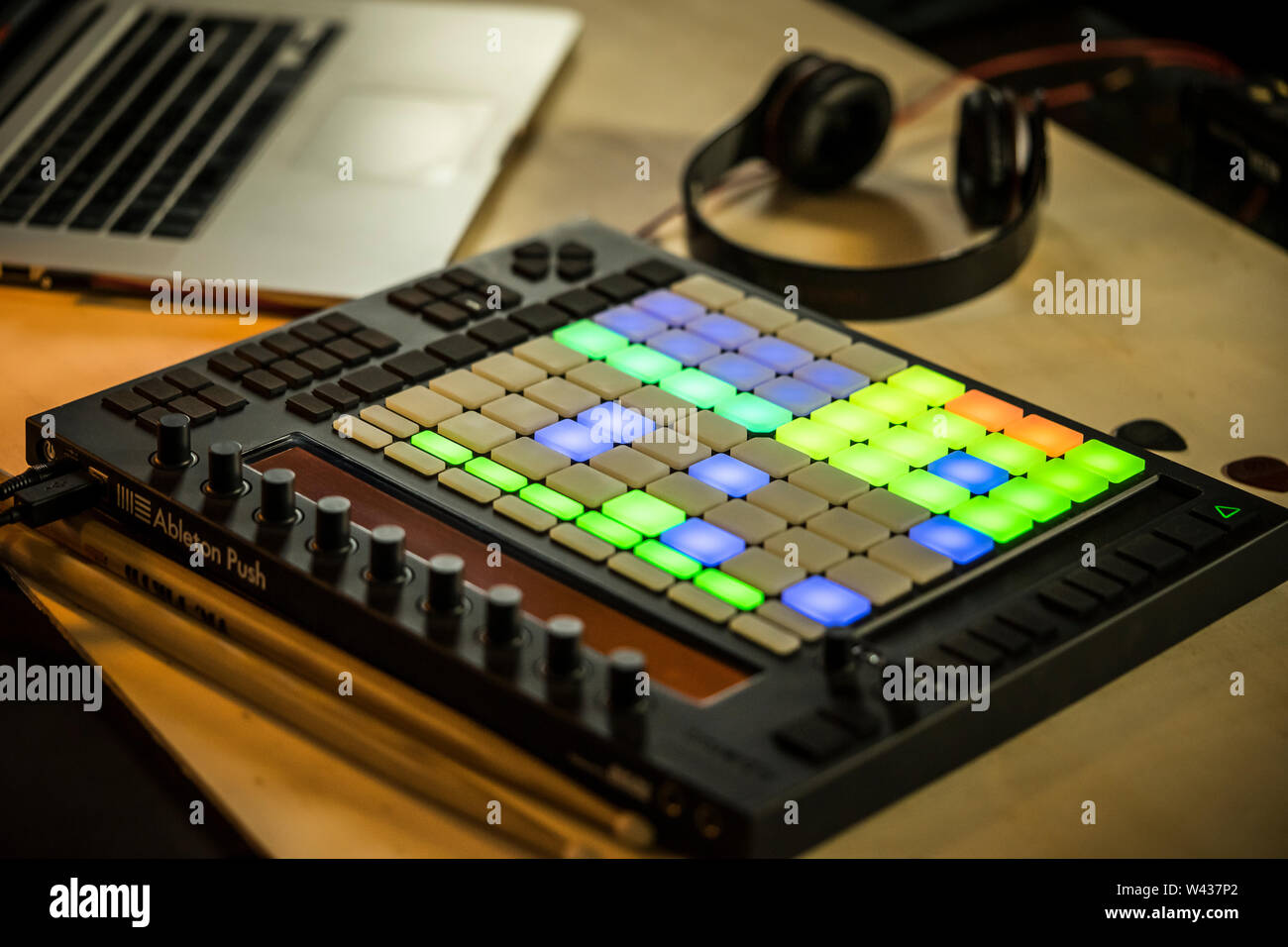 Home music production. An Ableton Push midi pad controller with Macbook and Headphones Stock Photo