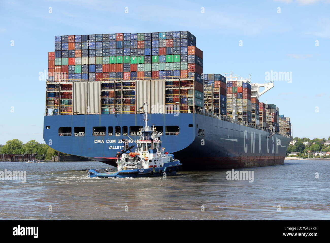 The container ship CMA CGM Zheng He leaves Hamburg harbor on May 11, 2019. Stock Photo