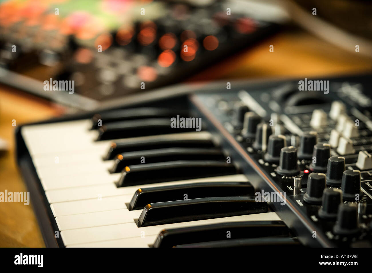 Electronic music production in a home studio. Closeup of an Arturia Minibrute synthesizer keyboard, with an Akai APC40 midi controller Stock Photo