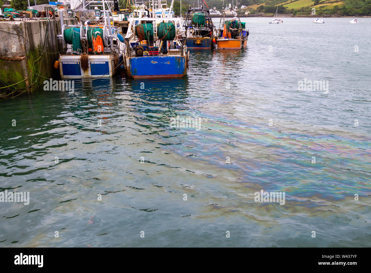 Diesel spill from trawler polluting sea in Union Hall harbour Ireland Stock Photo