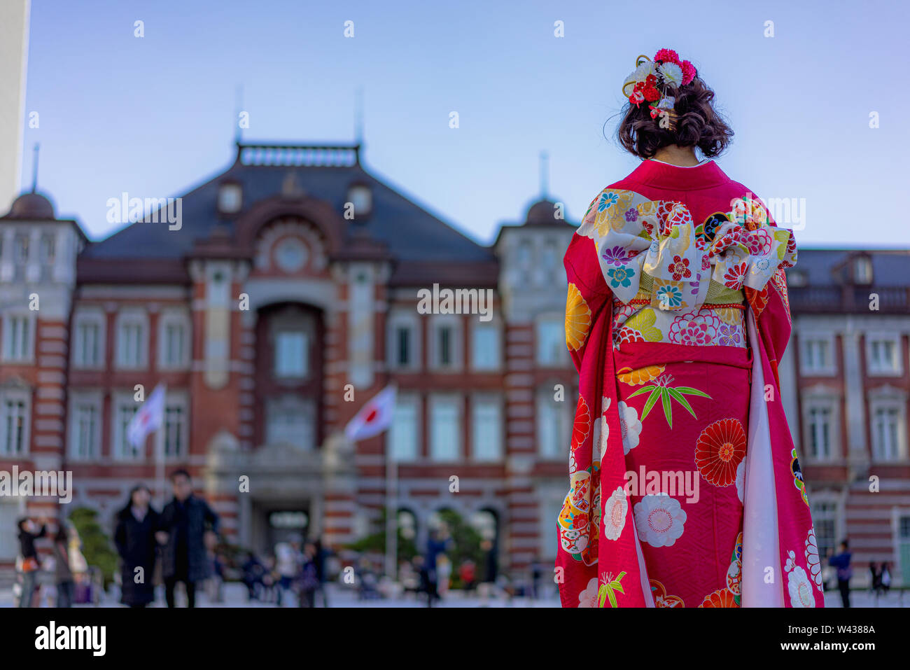 Tokyo, Japan. January 14, 2019. A woman poses in front of Tokyo station in traditional kimono dress during the coming of age holiday. Stock Photo