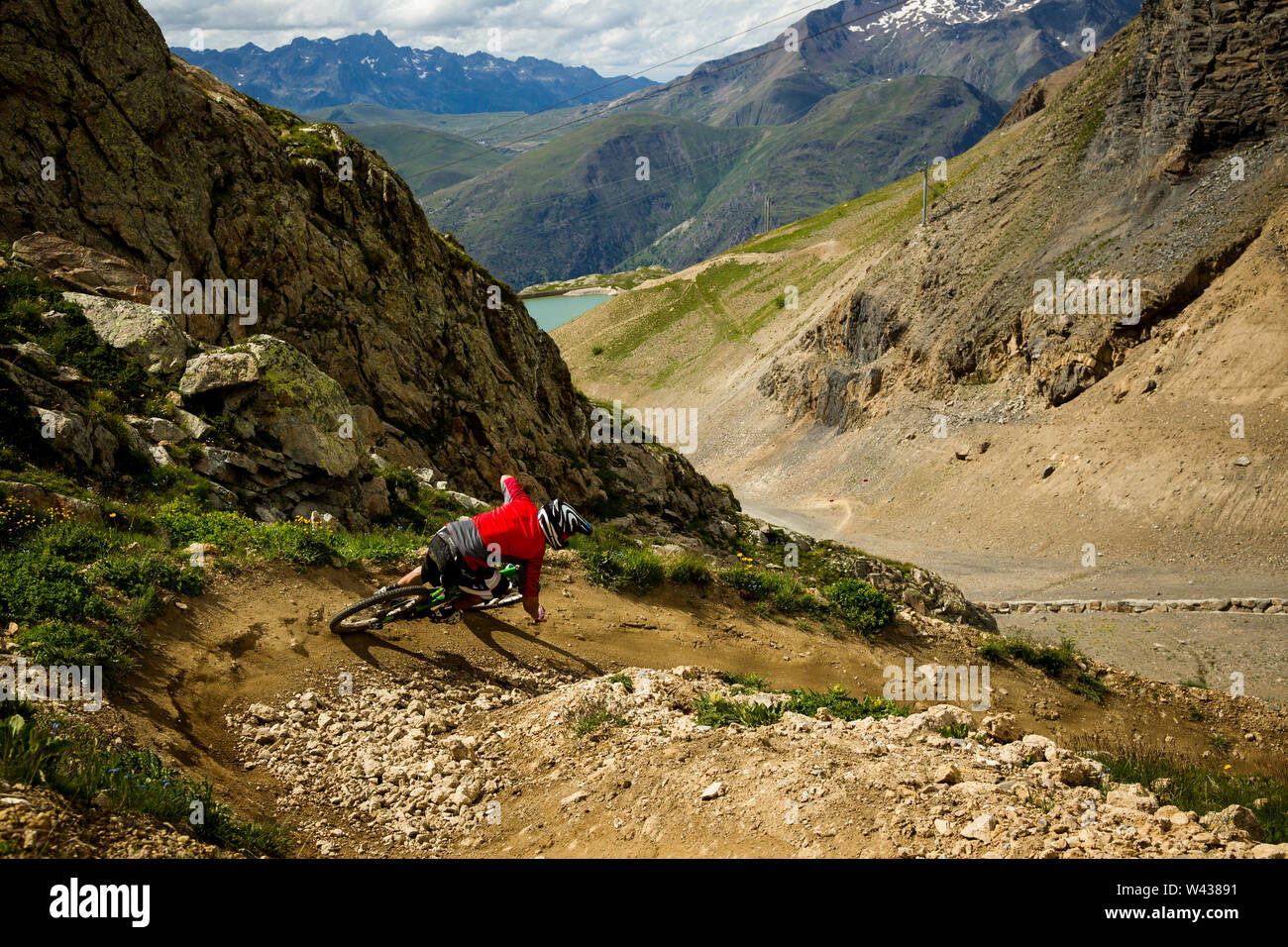A man rides a mountain bike around a tight corner on a purpose built