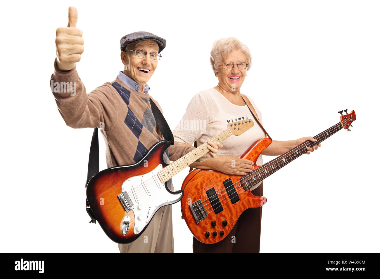 Elderly man and woman with electric guitars showing thumbs up isolated on white background Stock Photo