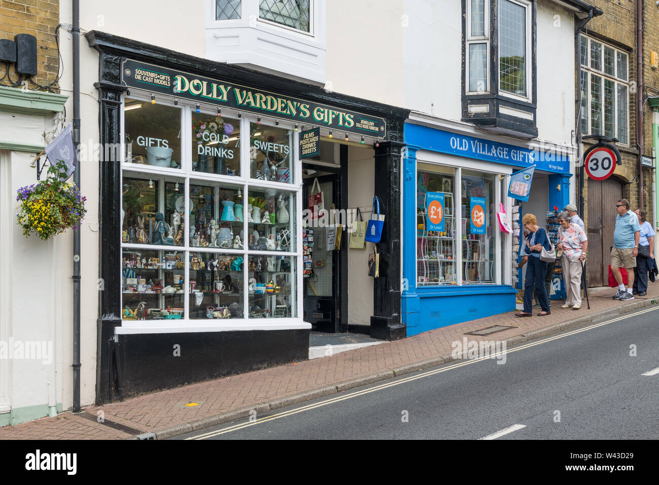 Holidaymakers in street window shopping outside Old Village Gifts and